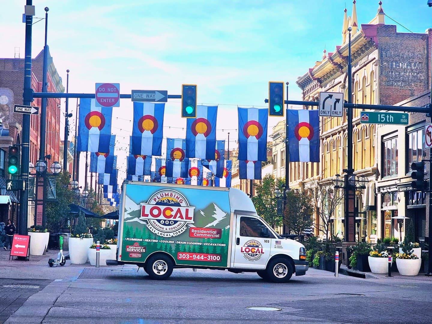 local phc branded van under colorado flags