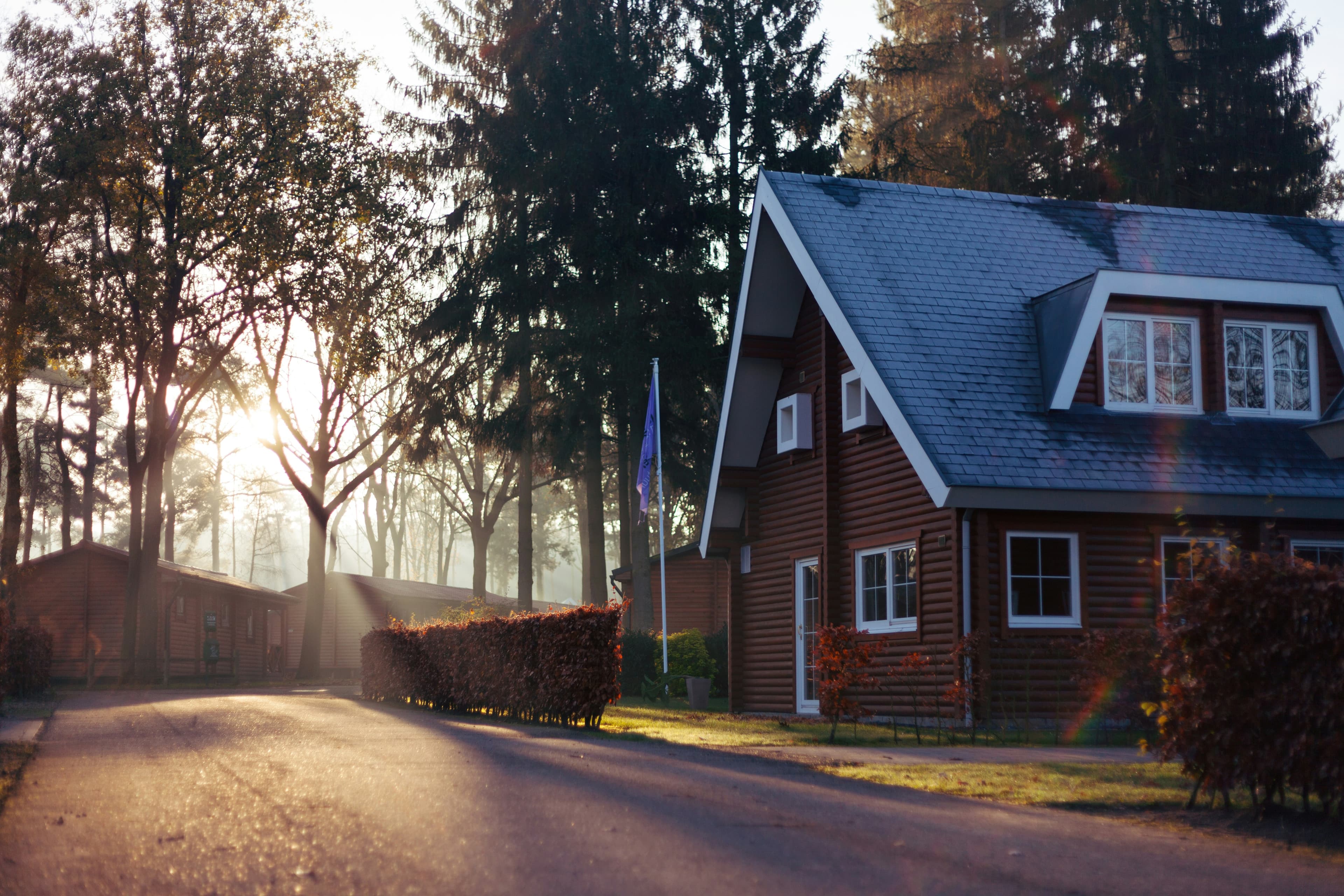 Brown and red house with sunset behind